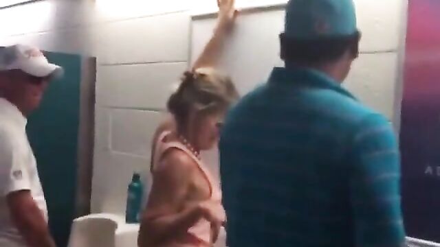 Drunk Miami Dolphins Female Fan With Big Ass Caught Using Men's Toilet - 4 image
