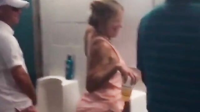 Drunk Miami Dolphins Female Fan With Big Ass Caught Using Men's Toilet - 5 image