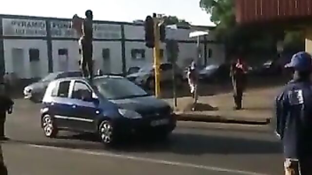 Naked Mad South African Woman With Big Ass Caught On A Car Roof In Public - 1 image