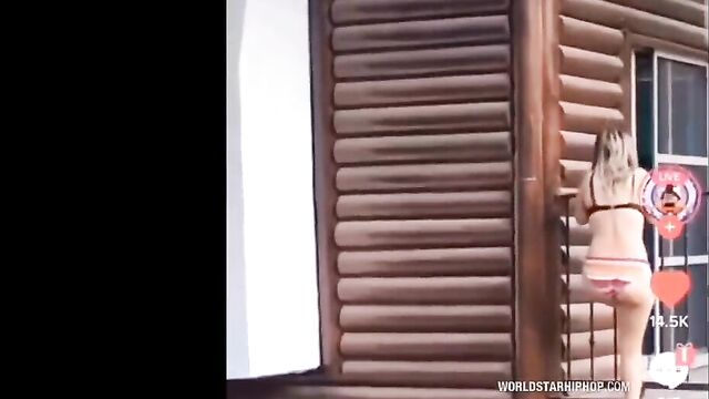 Side chick climbs down balcony in her panties in public to escape from angry wife who caught her with her cheating husband! - 1 image