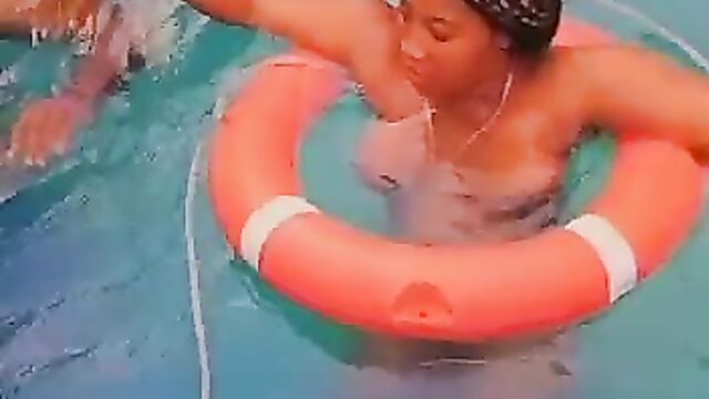 Naked African couple having sex in a pool in public