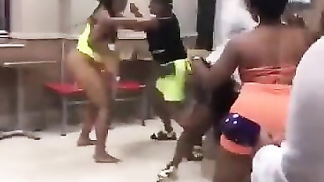 Strippers fighting, showing naked breasts and ass in a club