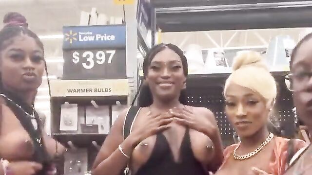 African girls showing their breasts in a store in public - 1 image
