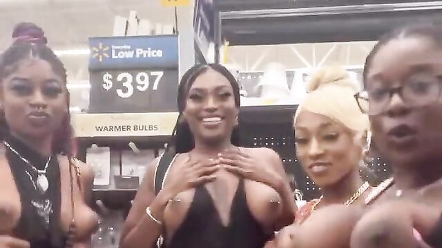 African girls showing their breasts in a store in public