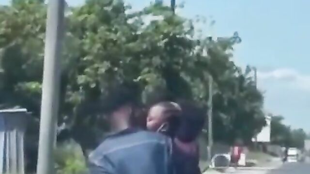 African couple making out in public on a bike