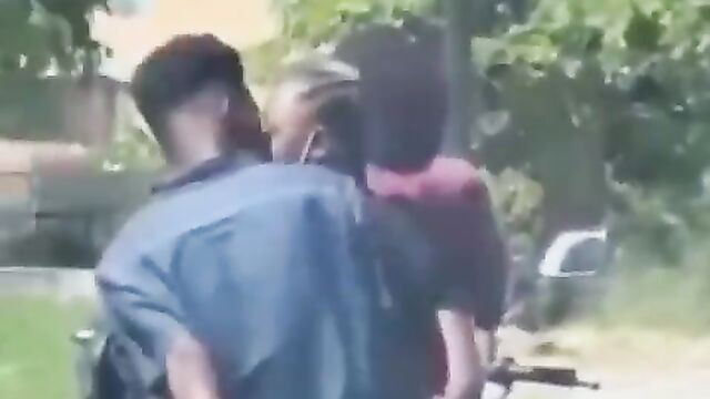 African couple making out in public on a bike - 5 image
