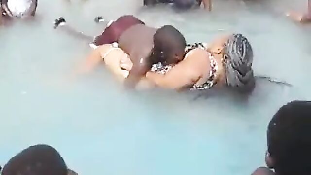 Young man removes lady’s panties in a pool and exposes her big ass in public, while being surrounded by children!