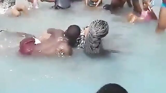 Young man removes lady’s panties in a pool and exposes her big ass in public, while being surrounded by children! - 3 image