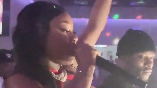 Suki rapping with her breasts out in public - 1 image