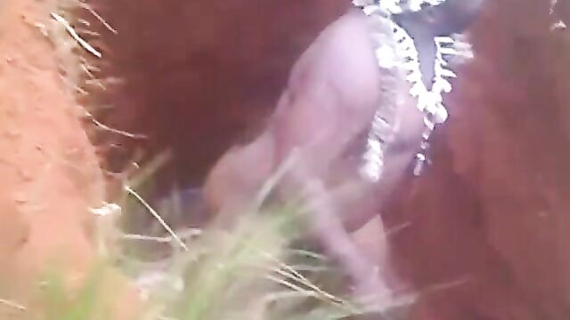 Naked native doctor performing rituals inside a grave