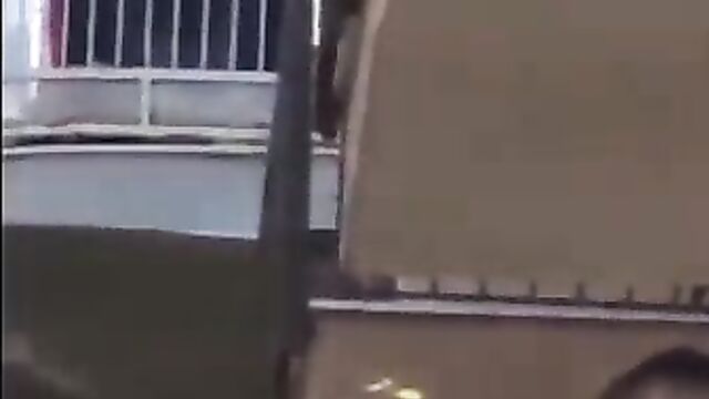 Bare breasts on the balcony