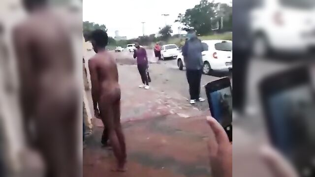 Two Naked Ebony Allegedly Mad Women Caught Lying In Front Of A Building - 5 image