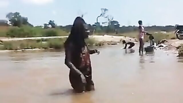 Boobs out in public as African girls with pointed breasts play in village river - 1 image