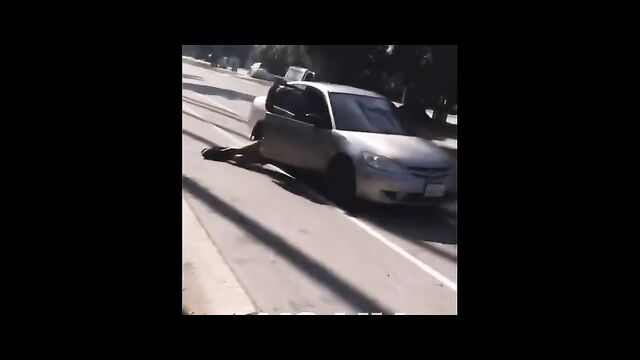 Dude holds on to wife’s car as she leaves him after she caught him cheating - 1 image