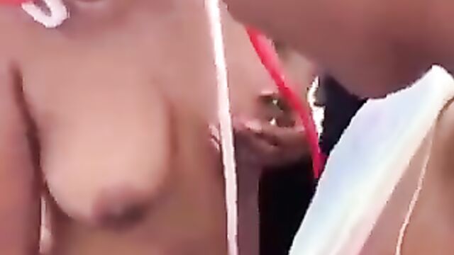 Woman puts money in girl’s pussy, as she shows breasts in public at a Lagos party